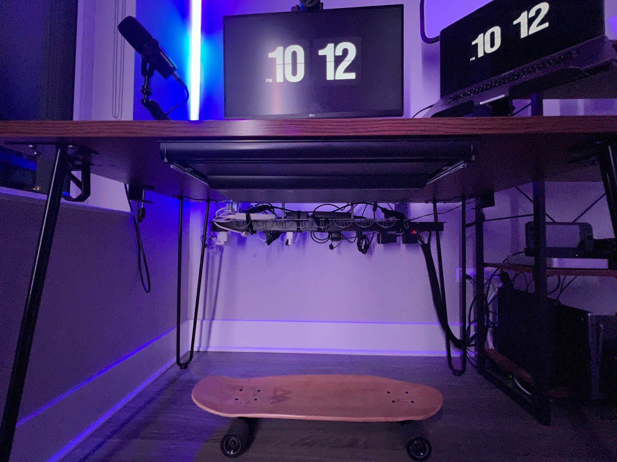 A view under the desk showing how the cable management system keeps mostly cables out of sight.